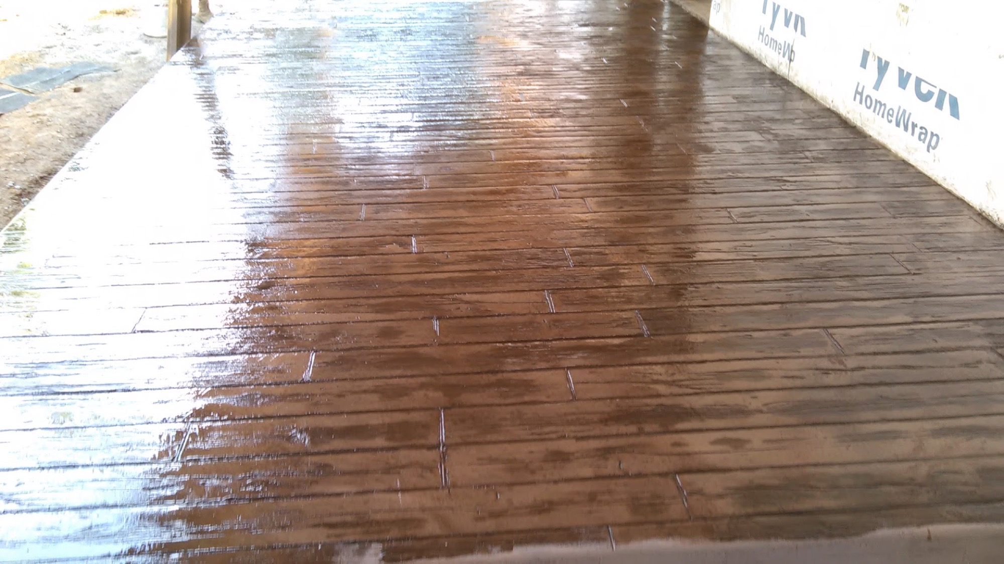 Stamped concrete with a rich stained finish, poured by T. Archer Concrete
