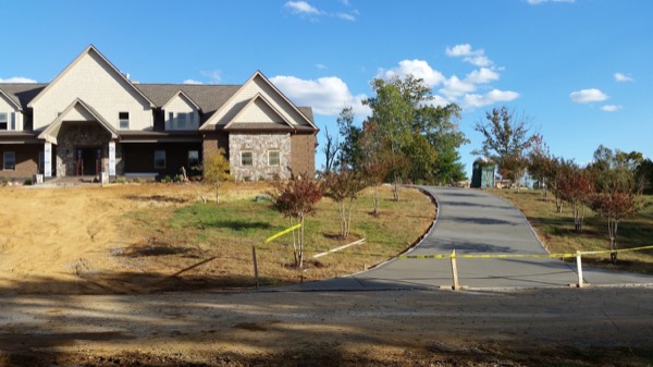 A sweeping concrete driveway at a newly built brick home near Friendsville, Tennessee