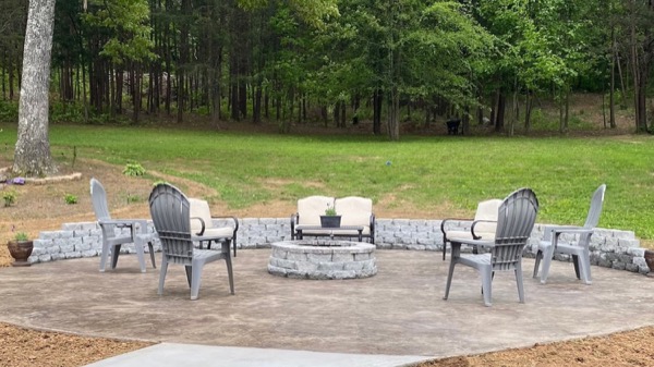 A concrete patio with a fire pit and seating wall, poured by T. Archer Concrete