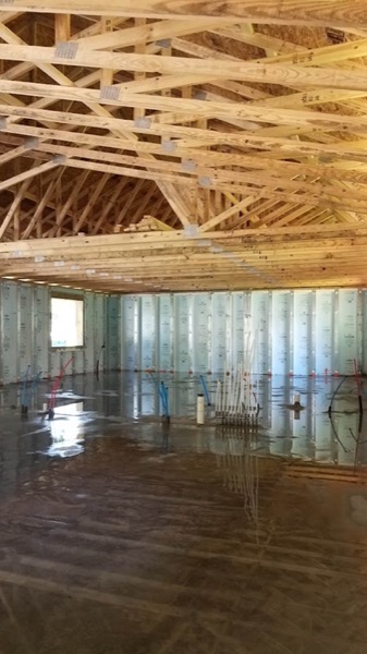 A finished concrete slab inside a framed garage
