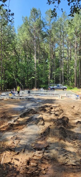 The crew setting out a slab and formwork on a cleared building site