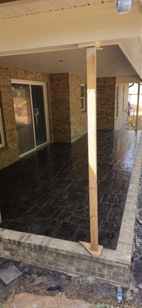 A stamped concrete floor under a covered porch