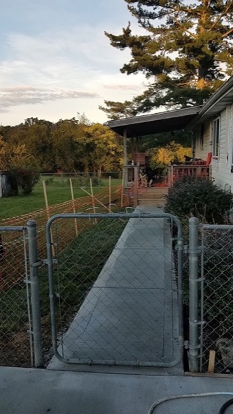 A concrete walkway leading through a gate