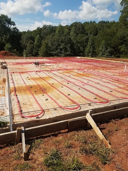 Radiant heat tubing tied out across a slab before the pour