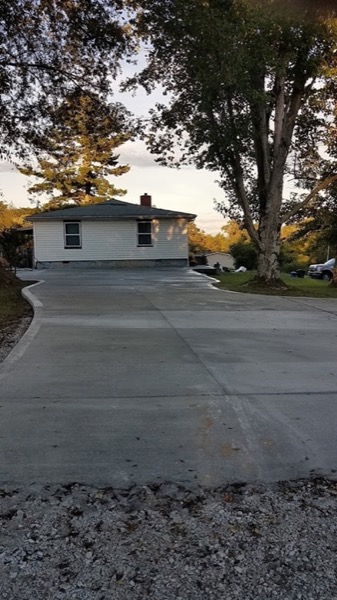 A concrete driveway finished at a family home
