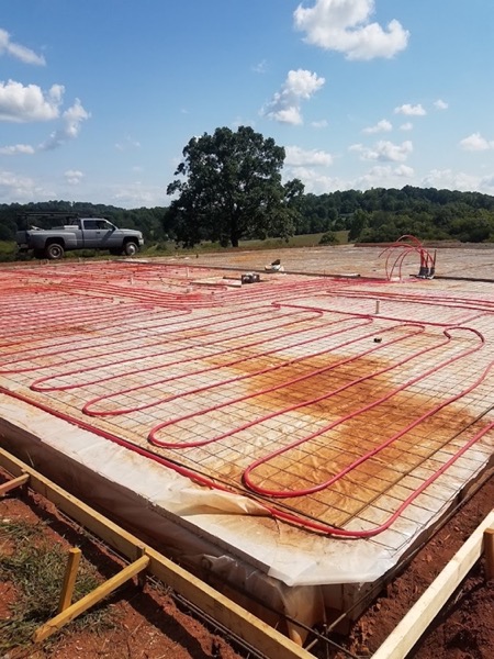 Radiant tubing set out across a formed slab ready to pour
