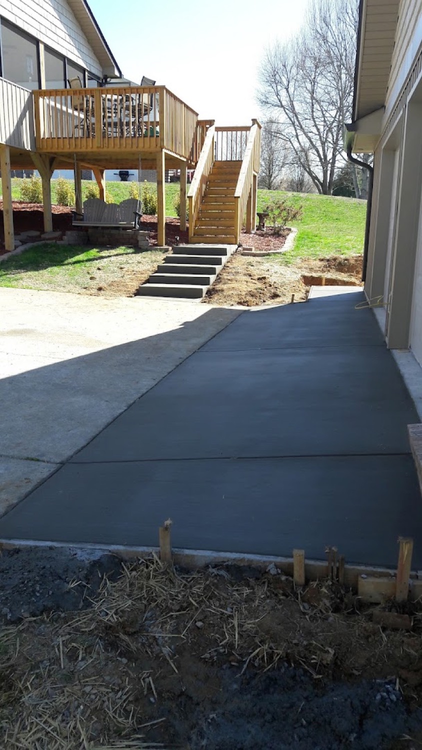 A concrete sidewalk running past a deck at an East Tennessee home